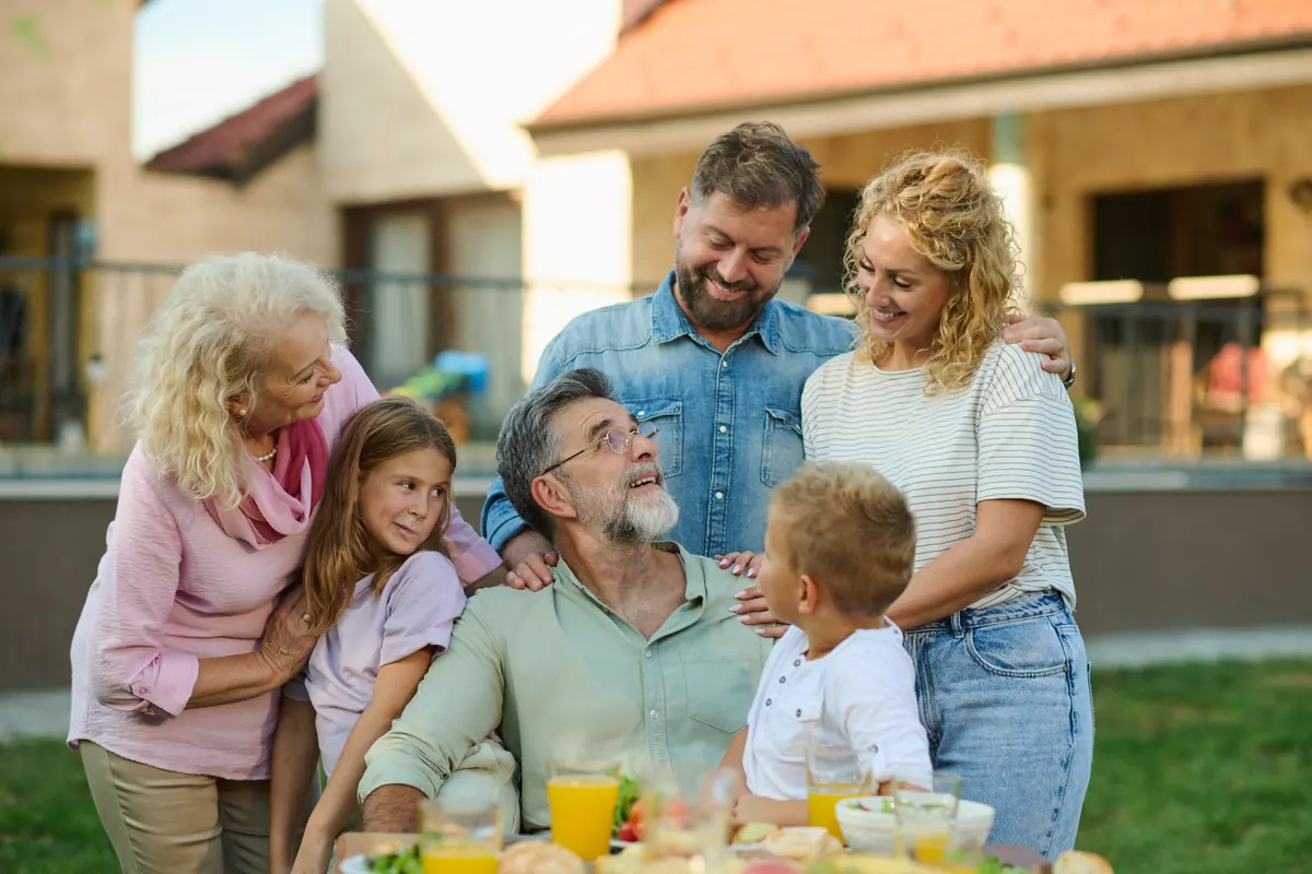 A multigenerational family enjoying lunch together outdoors