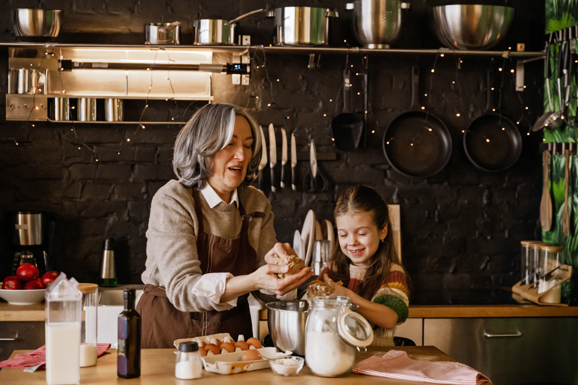 A grandmother and granddaughter baking together